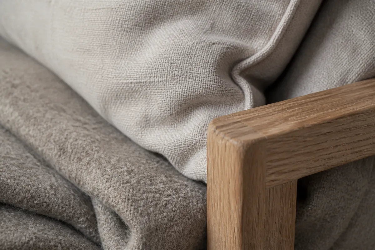 Detalle de lino, lana y madera en un reposabrazos